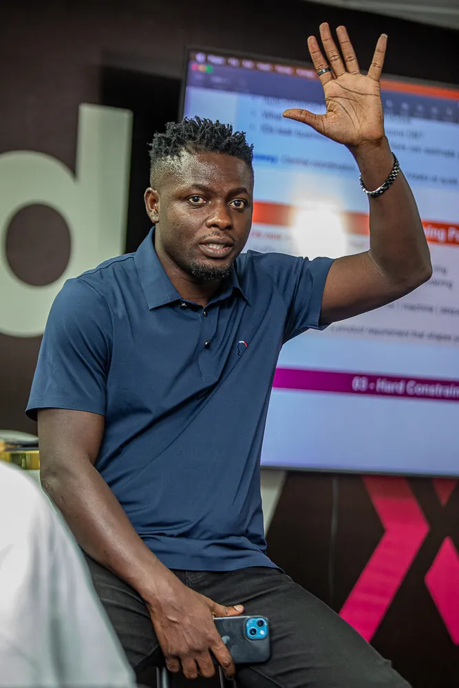 An attendee raising a hand during a discussion